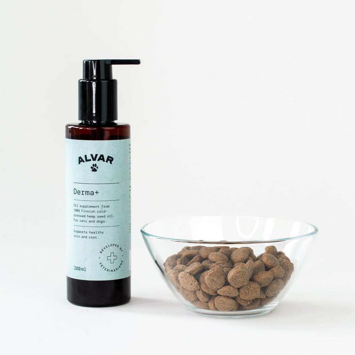 Bottle of Alvar Derma+ product next to a bowl of dog treats on a white background