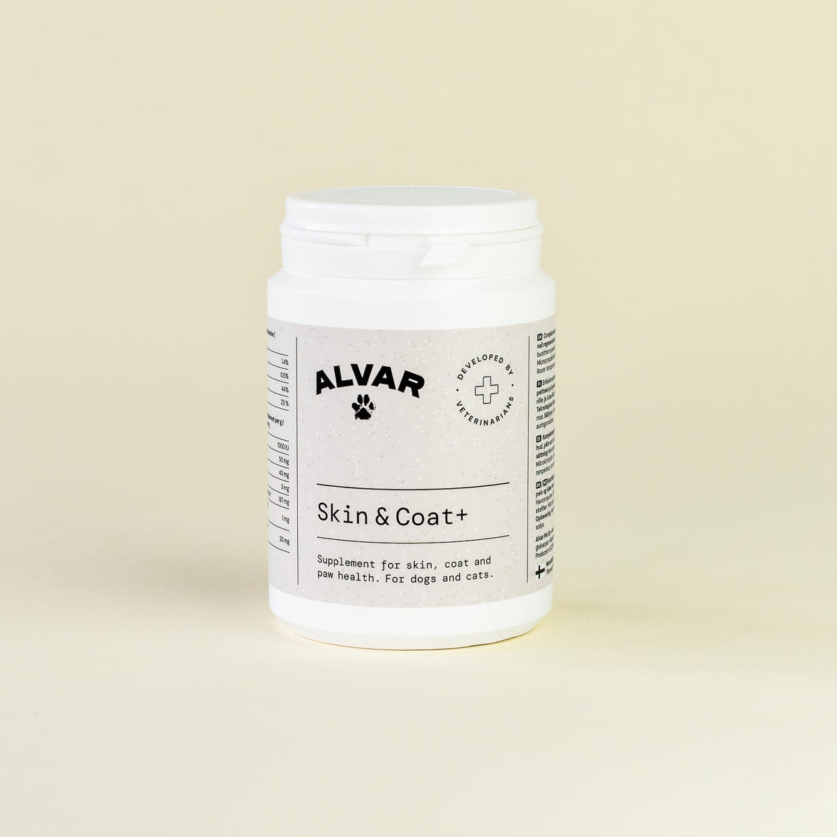 White supplement container with 'Alvar' label on a beige background
